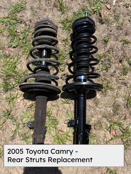 Old and new rear strut assemblies laid on the grass, from a 2005 Toyota Camry
