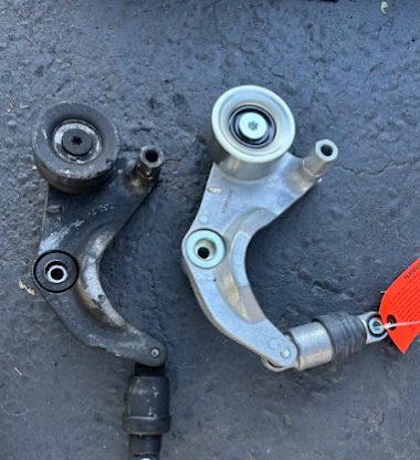 Old and new belt tensioners side by side from a 2006 Honda Civic