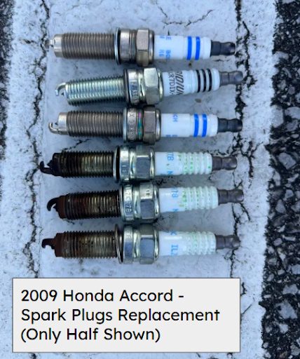 Worn spark plugs lined up next to new replacements, from a 2009 Honda Accord